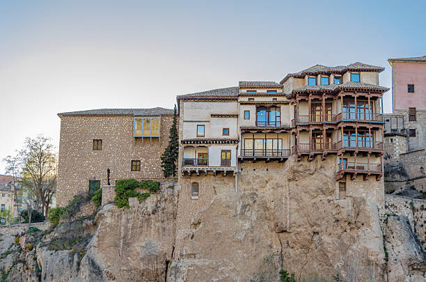 Cuenca, Spain - March 28, 2015: The Hanging Houses (Spanish: Casas Colgadas) in Cuenca, Spain. They are so named because part of them has a corbelled roof, or large balconies, jutting out from the high rocky ledge of the Huecar River gorge. The only three examples of this type of building that still survive are the House of the Mermaid and the two Houses of the Kings, built between the 13th and 15th centuries. They house the Museum of Spanish Abstract Art