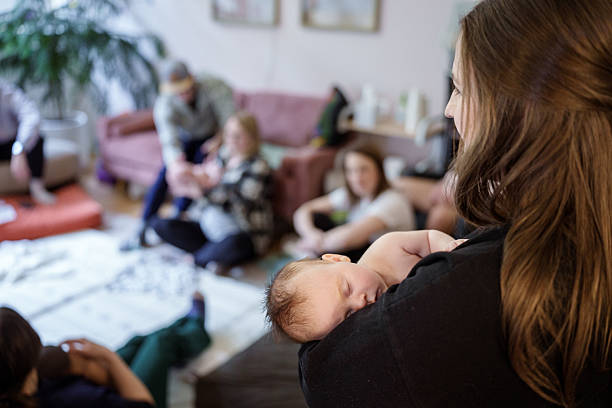 istock Sleeping baby in mother's arms 2238642463