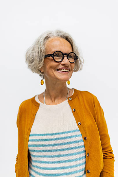 istock Smiling senior woman looking away in studio 2238643408