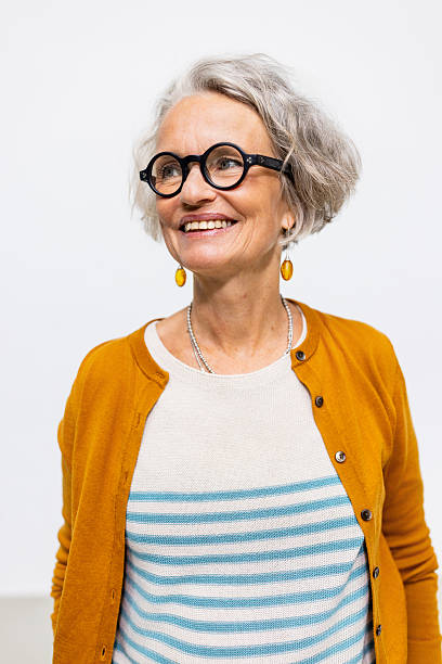 istock Smiling mature woman looking away on white studio background 2238643418