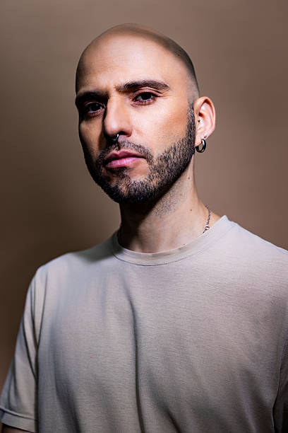 istock Handsome mid adult man staring at camera on brown background 2238643885