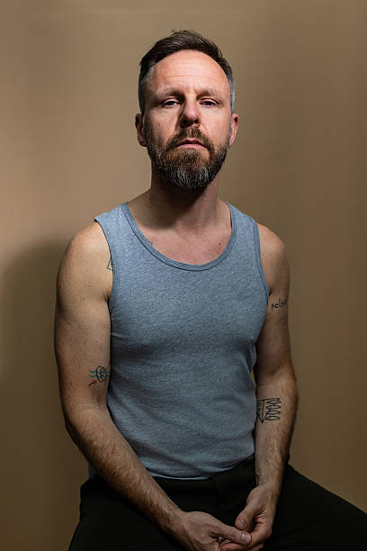 istock Stubborn mature man in grey vest staring at camera 2238643996