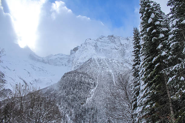istock Snow-covered mountains and coniferous forest under a winter sky 2238649229