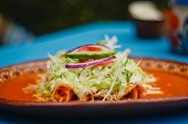 istock Authentic Mexican Red Enchiladas (Enchiladas Rojas) with Avocado and Cheese 2238651181