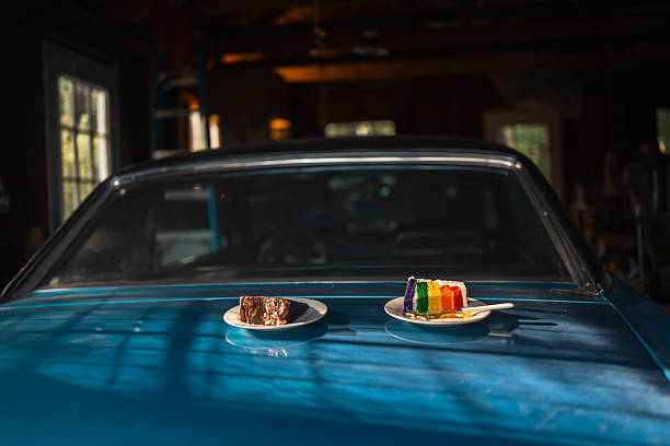 istock Vibrant Rainbow Cake Slices Resting on a Vintage Blue Car in Natural Light 2238653653