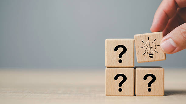 istock Questions and answers concept with wooden blocks showing question marks and brain light bulb icon, symbolizing problem solving, idea generation, and finding innovative solutions. 2238654735