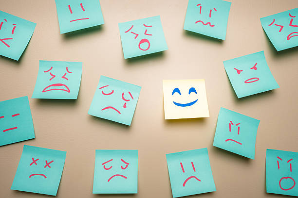 istock Positive Mindset Concept, Happy Face Among Sad Angry Standing Out 2238663892