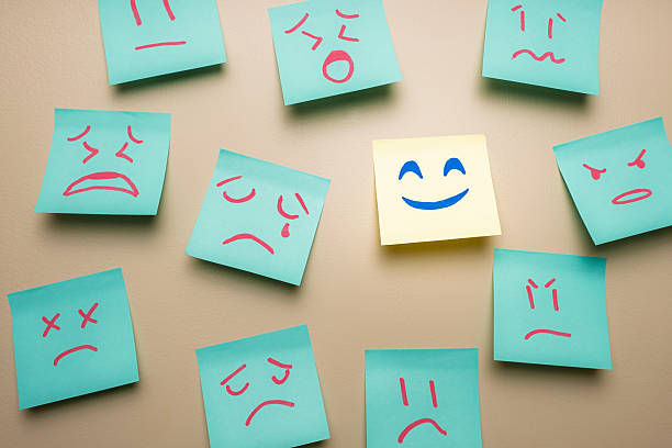 istock Positive Mindset Concept, Happy Face Among Sad Angry Standing Out 2238663897
