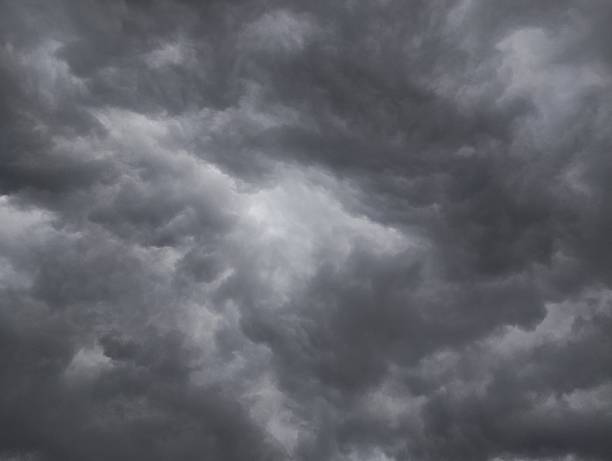 Dramatic dark storm rain clouds black sky background. Dark thunderstorm clouds rainny atmosphere. Meteorology danger windstorm disasters climate. Dark cloudscape storm disaster gloomy gray cloud sky