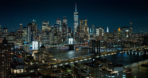 Aerial shot of Manhattan Financial District from DUMBO, Brooklyn at night.