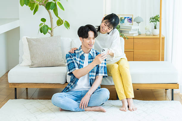 istock Couple looking at smartphone in living room 2238668075