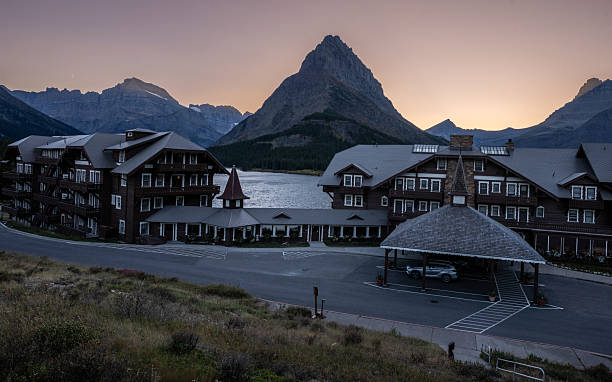 The historic Many Glacier Hotel rests along the shore of Swiftcurrent Lake as the sun sets behind the jagged peak of Grinnell Point. Built in 1915, this Swiss chalet–style lodge is one of the crown jewels of Glacier National Park, offering visitors a timeless connection between rustic architecture and Montana’s alpine wilderness.