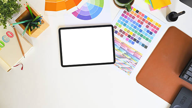 istock Graphic designer workspace with tablet and color palette charts on white desk for design project 2238672649