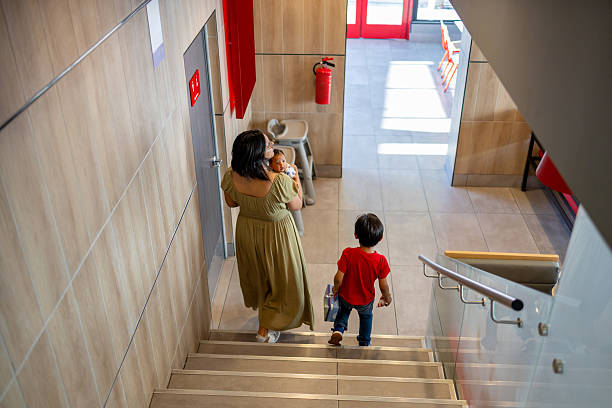 istock Mother walking down a staircase with her children in a restaurant 2238673379