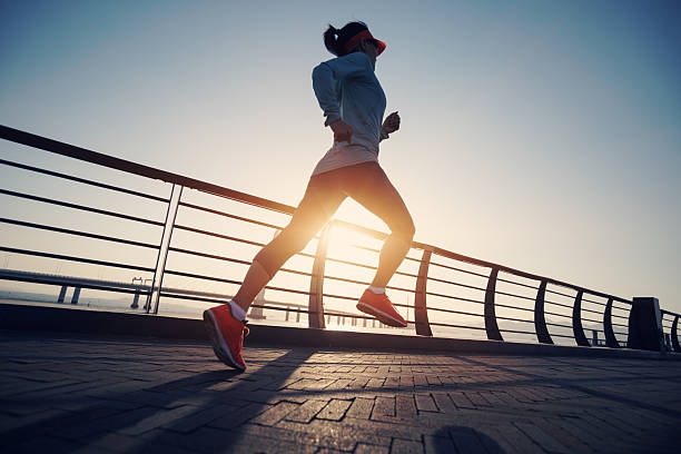 istock Fitness woman runner running on seaside bridge 2238674455