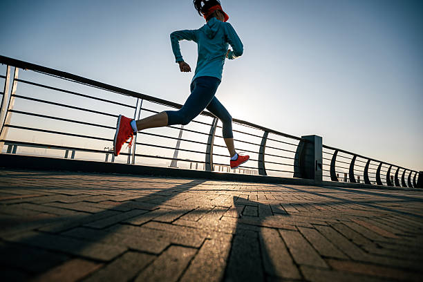 istock Fitness woman runner running on seaside bridge 2238674487