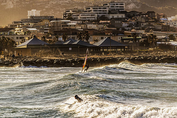 Windsurfers in the storm, by a strong Mistral day in Marseille, city situated by the mediterranean sea in the Provence region of southern France.The mistrali is a strong, cold, northwesterly wind that blows from southern France into the Gulf of Lion in the northern Mediterranean.