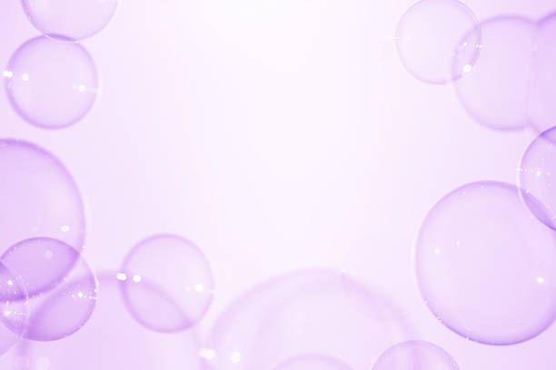 Beautiful Clear Purple Soap Bubbles Floating in The Air. Celebration Festive Backdrop. Freshness Soap Suds Bubbles Water. Purple and White Gradient Textured.