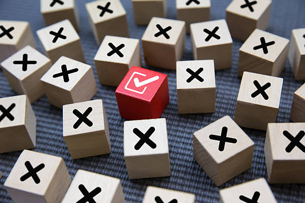 istock Close-up check mark on cube wooden toy block stack with cross symbol for true or false changing mindset or way of adapting to change leader and transform quiz answer and poll concept. 2238681677