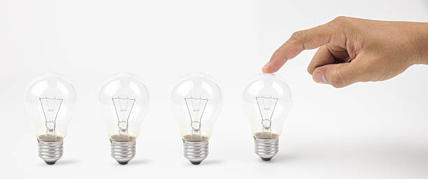 Close up hand choose light bulb or lamp on white background concepts of genius create or human resources for business leadership and creativity thinking idea or knowledge learning and innovation.