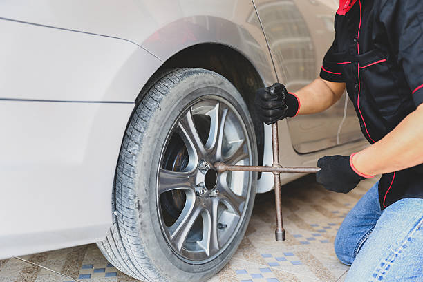 istock Car care maintenance and servicing, Close-up hand technician auto mechanic using wrench change tire concept of repairing and fix car problem and insurance service support. 2238681731