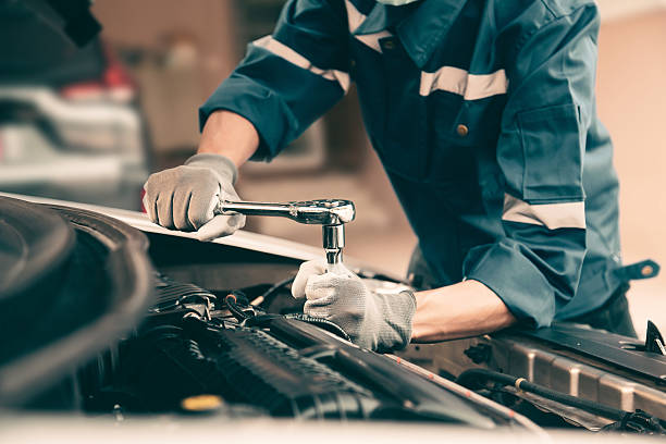 istock Car care maintenance and servicing, Close-up hand technician auto mechanic using the wrench to repairing change spare part car engine problem and car insurance service support. 2238681775