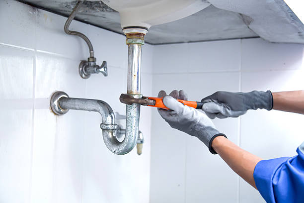 istock Technician plumber using a wrench to repair a water pipe under the sink. Concept of maintenance, fix water plumbing leaks, replace the kitchen sink drain, cleaning clogged pipes is dirty or rusty. 2238681780