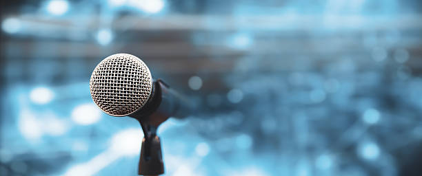 istock Microphone Public speaking backgrounds, Close-up the microphone on stand for speaker speech presentation stage performance with blur and bokeh light background. 2238682187