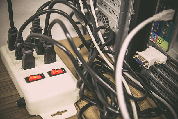 istock Old and damaged electric adapter power plug has many appliances are plugged outlet socket concept of risk danger overloaded current electrical. 2238682339