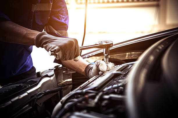 istock Car care maintenance and servicing, Close-up hand technician auto mechanic using the wrench to repairing change spare part car engine problem and car insurance service support. 2238682479