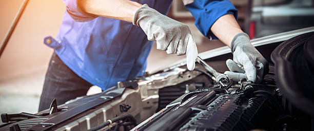 istock Car care maintenance and servicing, Close-up hand technician auto mechanic using the wrench to repairing change spare part car engine problem and car insurance service support. 2238682480