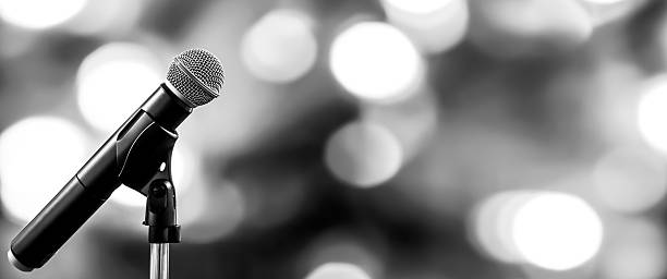 istock Microphones Public speaking background, Close up microphone on stand for speaker speech presentation stage performance or press conference backgrounds. 2238682695