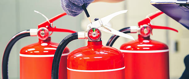 istock Fire extinguisher has hand engineer inspection checking pressure gauges to prepare fire equipment for protection and prevent in emergency case and safety or rescue and alarm system training concept. 2238683149