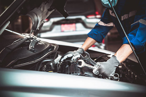 istock Car care maintenance and servicing, Close-up hand technician auto mechanic using the wrench to repairing change spare part car engine problem and car insurance service support. 2238683427