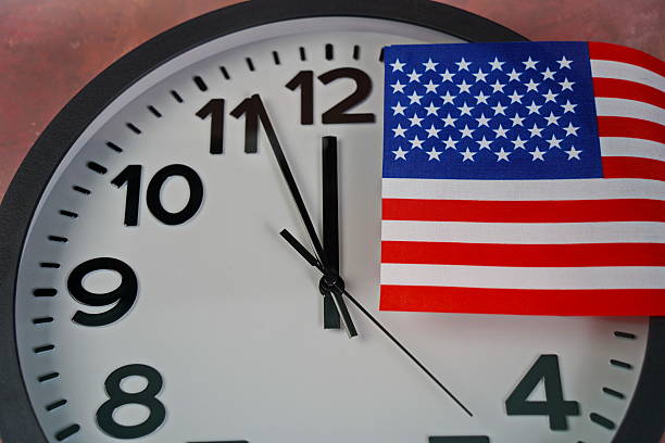 istock The US flag on the clock face on a paper background. 2238685068