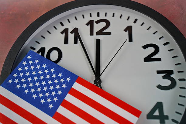 istock The US flag on the clock face on a paper background. 2238685070