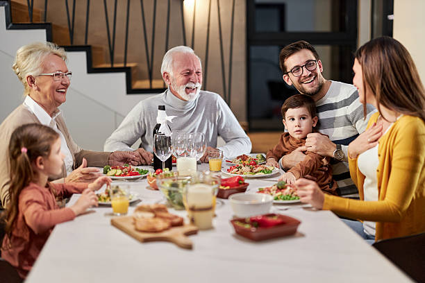 istock Happy extended family talking during lunch in dining room. 2238685429
