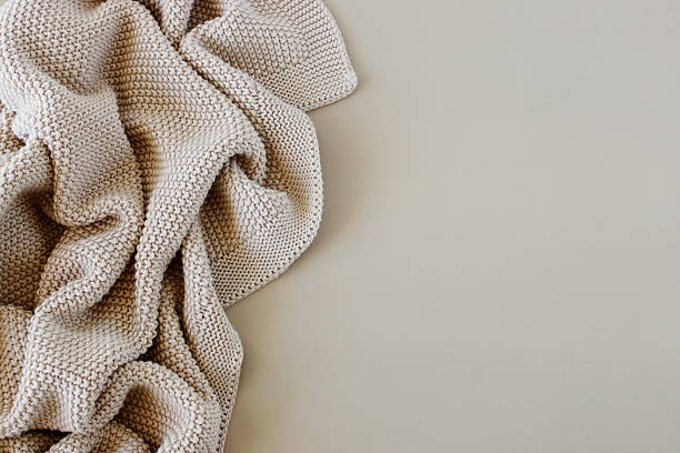 istock Beige knitted blanket on beige background with copy space template 2238685501