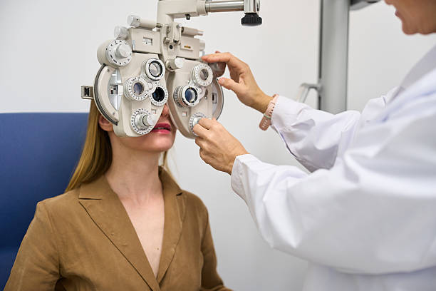 istock Optometrist conducting eye exam using phoropter for patient 2238685650