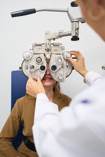 istock Optometrist examining female patient vision with phoropter 2238685663