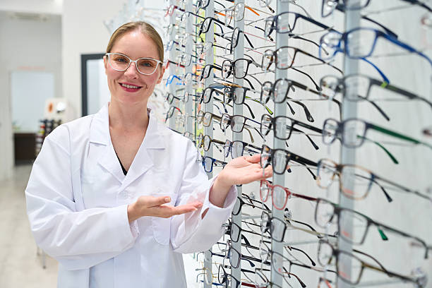istock Optician in optical shop presenting eyeglasses selection 2238685928
