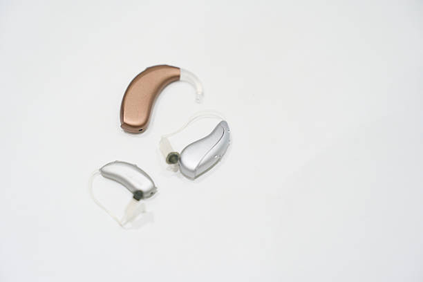 Three hearing aids on a white background, representing advancements in medical technology for hearing loss and accessibility