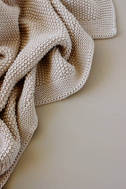 istock Beige knitted blanket on beige background with copy space template 2238686152