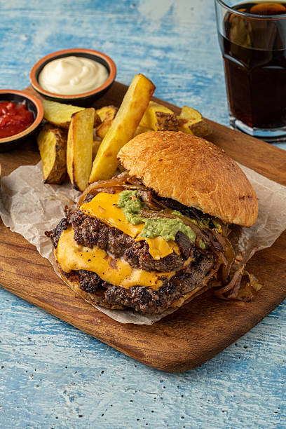 istock Smash burger with cheddar cheese and caramelized onions, served with fries 2238686951