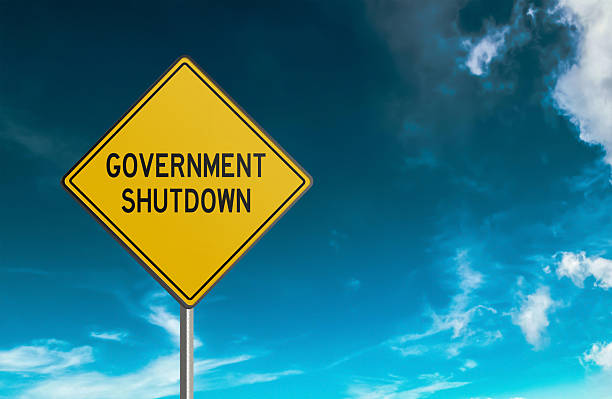 istock Government Shutdown yellow road sign 2238687809