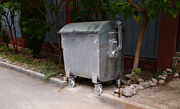 istock single garbage bin on the sidewalk of an urban area 2238687962