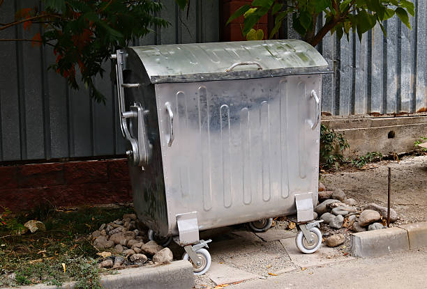 istock single garbage bin on the sidewalk of an urban area 2238687976