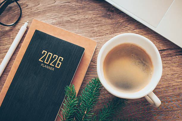 istock Cozy Workspace With 2026 Planner, Coffee, and Greenery on Wooden Desk 2238688386