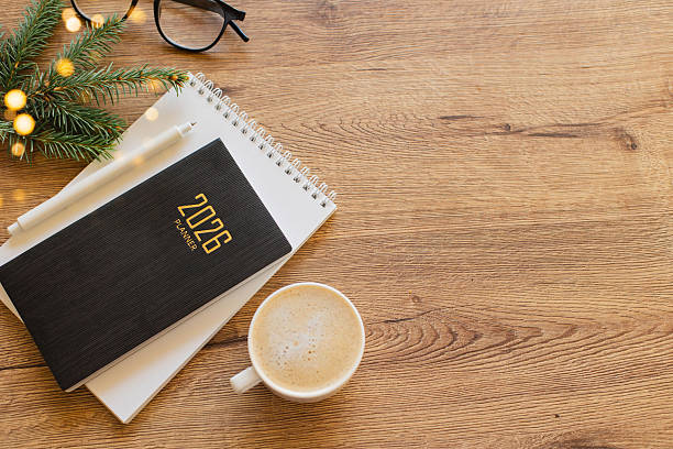 istock Stylish Desk Setup With 2026 Planner, Notebook, Pencil, Glasses, Fir tree Branch and Coffee on Wooden Surface 2238688567