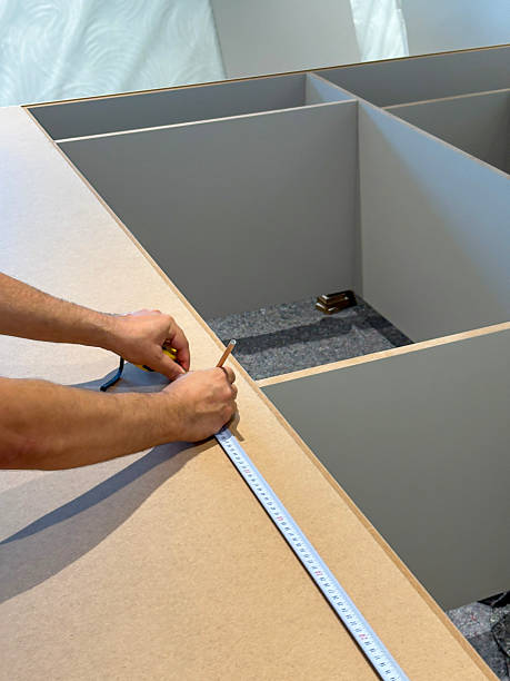 istock Carpenter installing cabinet. Making furniture. DIY concepts 2238688742